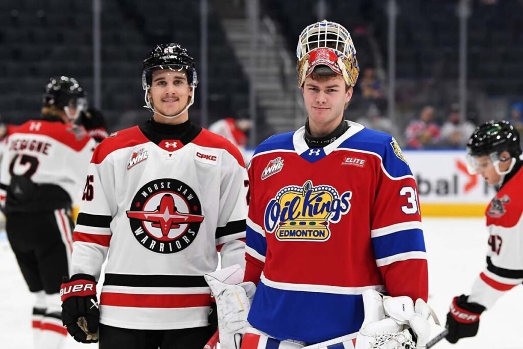 two young hockey players pose for a picture